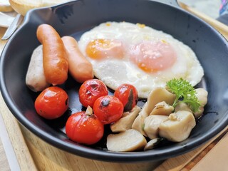 English breakfast - fried egg,tomatoes, mushrooms,  and toast. Top view