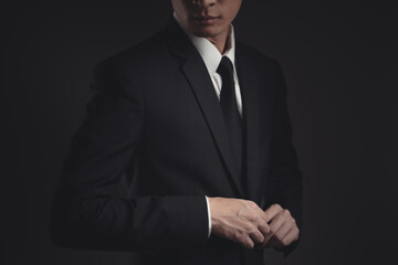 Close up shot of businessman in black suit.