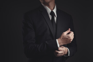 Close up shot of businessman in black suit.