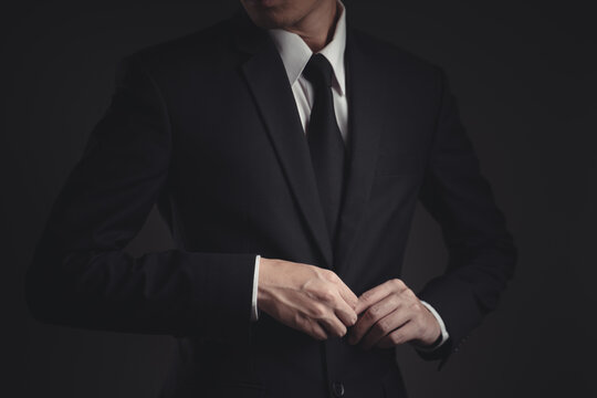 Close up shot of businessman in black suit.