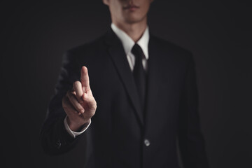 Businessman presenting in black suit.