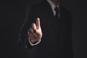 Businessman presenting in black suit.