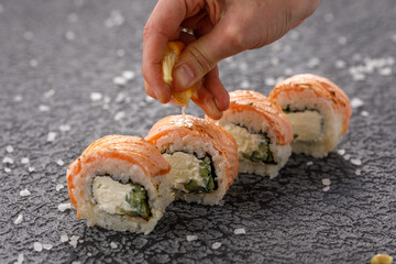 Sushi rolls Baked Philadelphia on textured still life background. Restaurant concept. Close-up.