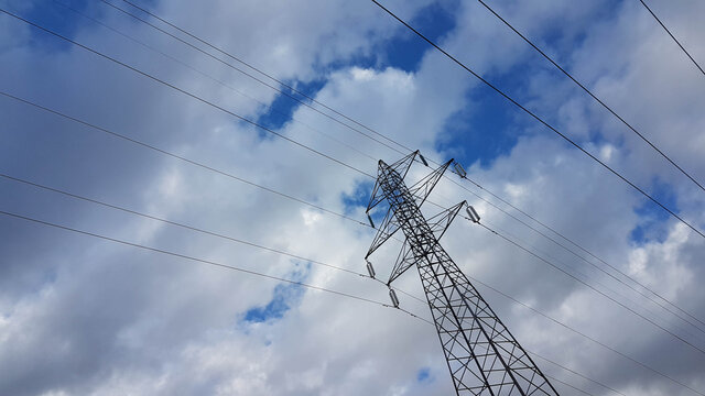 electricity pylons cords  blue sky clouds
