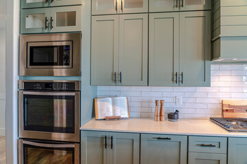 Electrical appliances and cooking tools inside the clean kitchen of a home