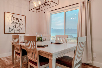 Dining area for four persons that looks out to scenic view of lake and mountain