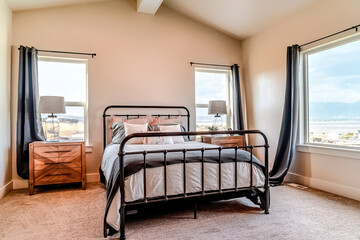 Bedroom interior with metal framed double bed and side tables with lampshades