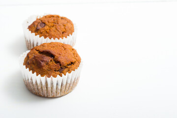 pair of chocolate muffins on white table