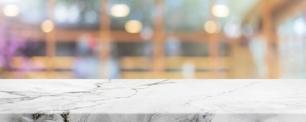 Empty white marble stone table top and blur glass window interior cafe and restaurant banner mock up abstract background - can used for display or montage your products.