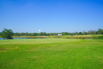 Beautiful golf course in a sunny day. Background evening golf course has sunlight shining down. Golf course in the countryside