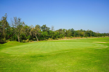 Beautiful golf course in a sunny day. Background evening golf course has sunlight shining down. Golf course in the countryside