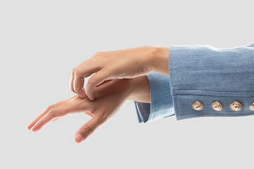 Businesswoman scratching her back of hand because of the itching from irritation.