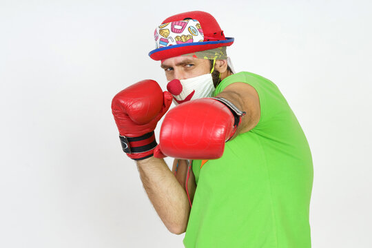 The clown plays boxing. Isolated on white