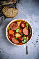 Sausages and vegetables soup.top view.style vintage.