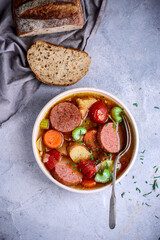 Sausages and vegetables soup.top view.style vintage.