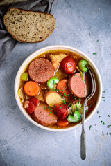 Sausages and vegetables soup.top view.style vintage.