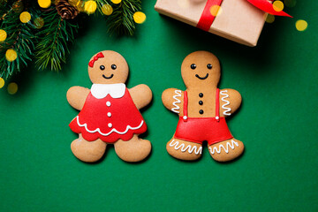 Beautiful Christmas background with Gingerbread couple, Christmas trees and gift.Top view
