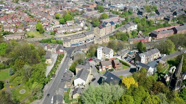 Aerial photo of the village of Morley in Leeds UK, showing an aerial view of the main street and residential houses on a bright sunny day in the spring time