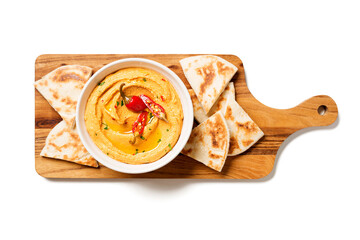 Roasted red pepper hummus with pita bread isolated on white background.