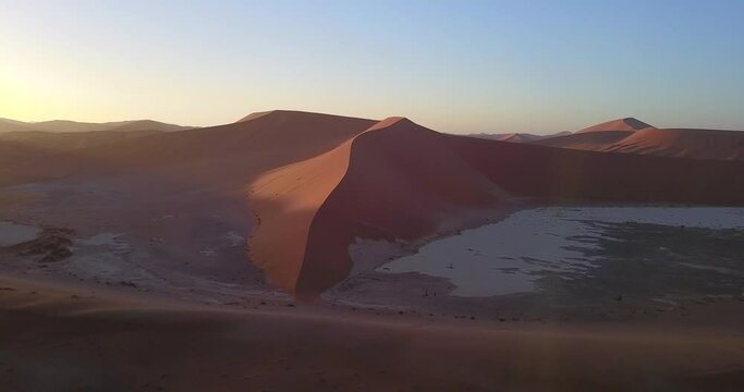4K aerial drone footage of famous endless sand sea and Sossusvlei Namib Desert scenic red sand dunes on sunny morning in Namib-Naukluft Park in Namibia, southern Africa