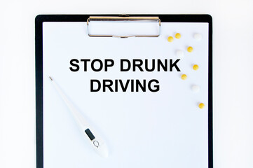 ON the tablet for writing tets STOP DRUNK DRIVING, next to the thermometers and yellow tablets.