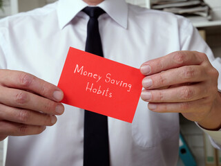  Financial concept meaning Money Saving Habits with inscription on the piece of paper.