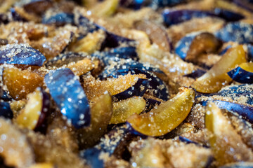 Sweet plum jam with sugar syrup is cooking