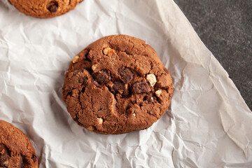 Chocolate cookies on white torn paper.