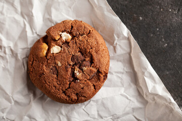 Chocolate cookies on white torn paper.