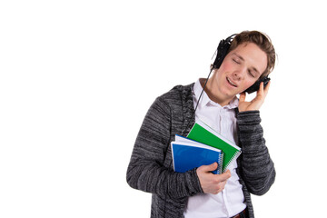 Student on a white background. Young attractive guy listens to music.