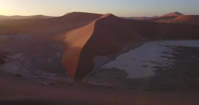 4K aerial drone footage of famous endless sand sea and Sossusvlei Namib Desert scenic red sand dunes on sunny morning in Namib-Naukluft Park in Namibia, southern Africa