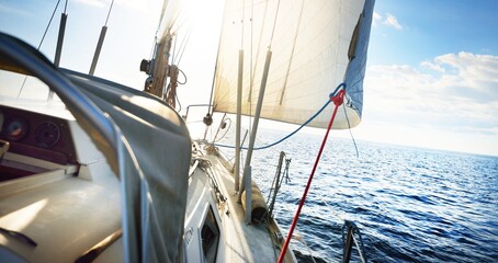 View forward from a sailboat tilted by the wind. Sea, waves and water splashes. clear blue sky. Transportation, nautical vessel, cruise, sport, regatta, recreation, leisure activity © Alex Stemmer