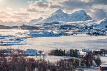 Aerial landscape photography. Amazing evening view of Bostad village, Vestvagoy island, Norway, Europe. Splendid winter scene of Lofoten Islands. Norwegian seascape. Life over polar circle.