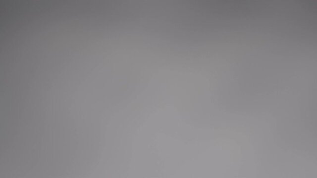 Blurry dark shadows moving on the wall. Spooky shadow art noise texture. closeup the motion of shadow batten of lath light on white wall texture background. Slow motion video. stock footage