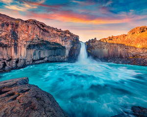 Astonishing summer scenery. Gorgeous evening view of Ingvararfoss waterfall. Fantastic summer sunset on Iceland, Europe. Beauty of nature concept background.