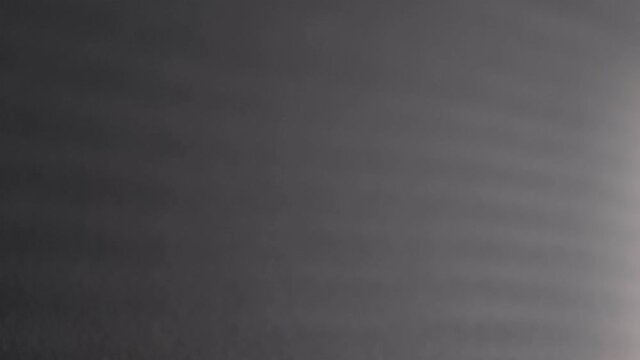 Blurry dark shadows moving on the wall. Spooky shadow art noise texture. closeup the motion of shadow batten of lath light on white wall texture background. Slow motion video. stock footage