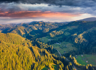 Beautiful summer scenery. Dramatic morning view of Carpathian mountains, Snidavka village location, Ukraine, Europe. Magnificent landscape of mountain hills glowing by sunlight.