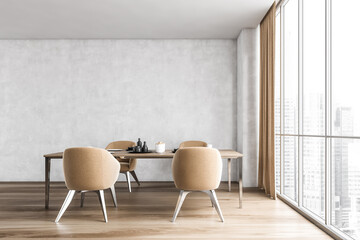 Dining room with four beige chairs and table near window on wooden floor