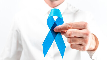 Prostate care. Awareness prostate of men health in November. Hipster men in bright shirt with blue ribbon in hands on white background. World cancer day and world diabetes day concept.