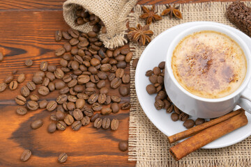 white cup of coffee, cappuccino with grains.