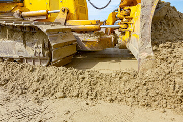 Crawler's tracks, bulldozer machine is leveling construction site