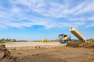 Tipper truck is unloading gravel from trailer