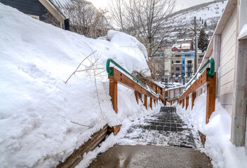Stairway on snowy slope in winter at a scenic neighborhood in the mountains