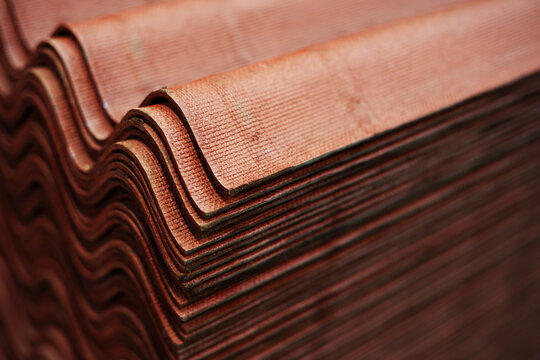 Roofing sheets of brown ondulin. Trade in building materials in a DIY store. Close-up. Many objects