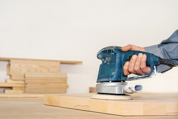 Carpentry works. Fragment of a grinding machine in the process of processing a wooden board....