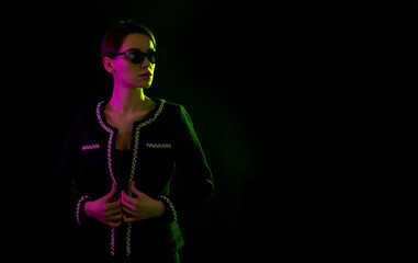 Fashionable woman in pink and green neon lighting. Cyberpunk light.