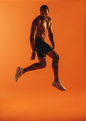 Fototapeta na wymiar Muscular man jumping in air during workout