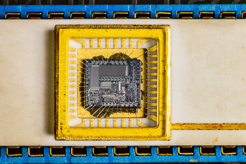 Old microprocessor with gold. Rare electronics pattern. Obsolete technology background.