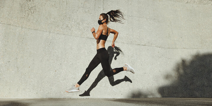 Fit woman sprinting outdoors