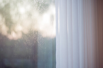 Defocused curtain window with sunlight in the early morning.